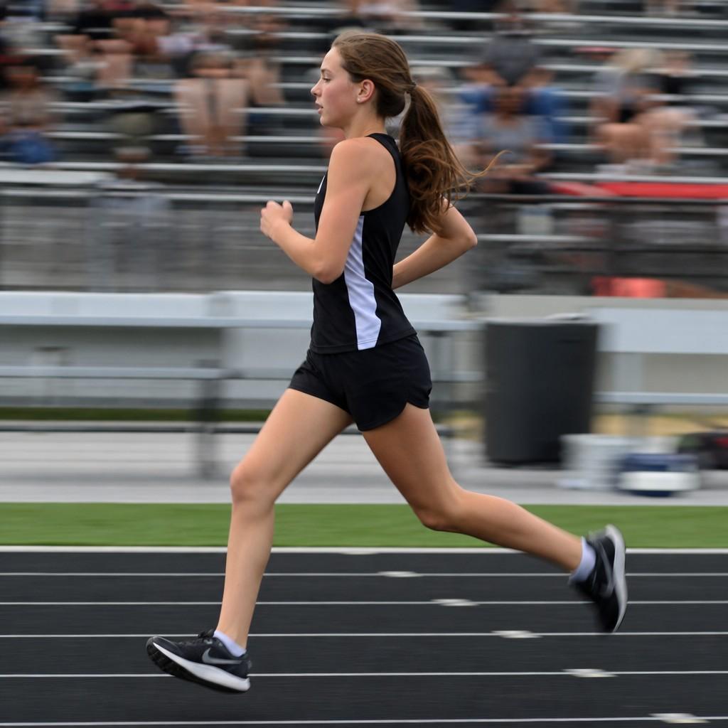 A sharp running athlete with a motion-blurred background
